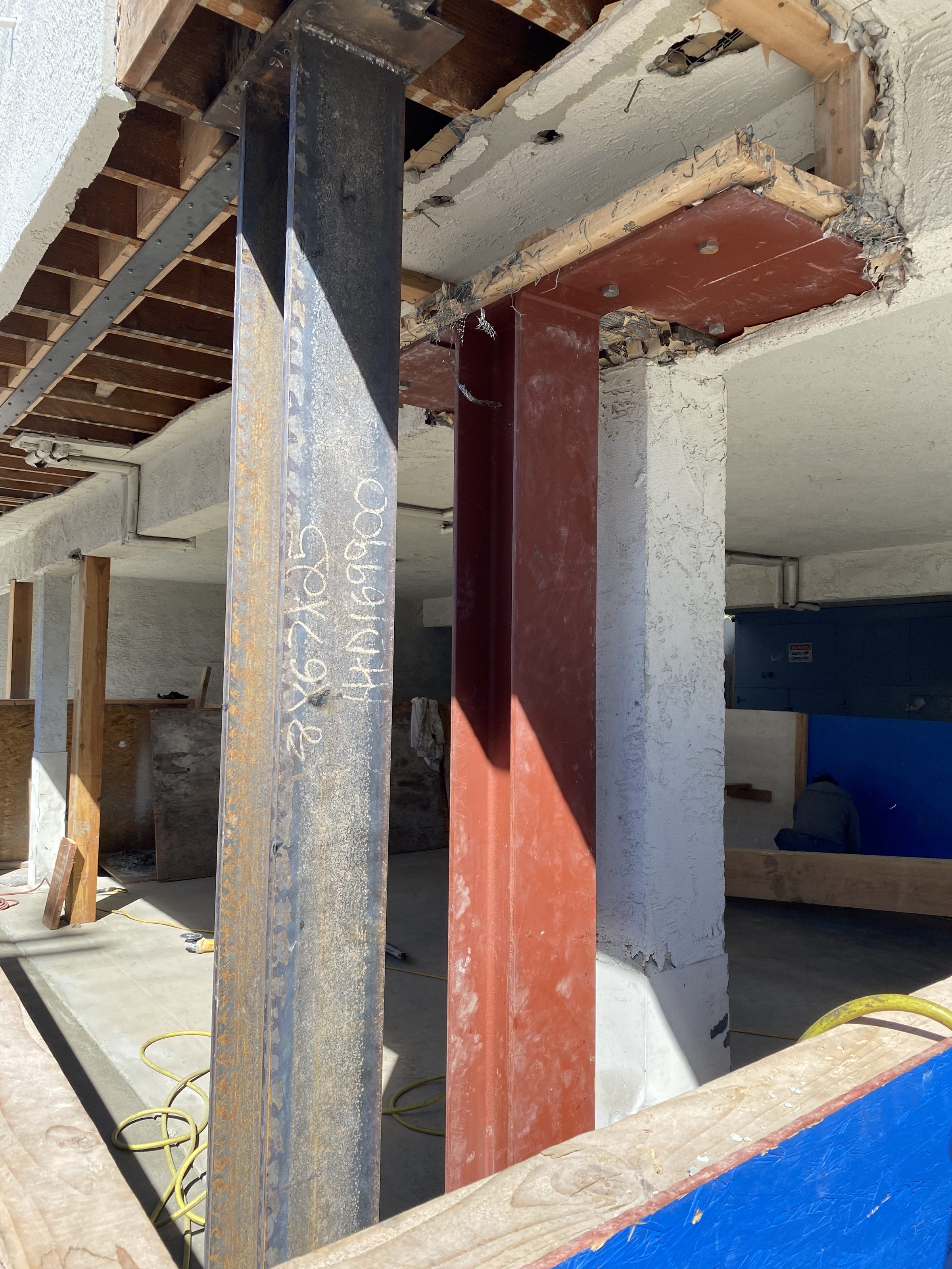 New steel column and moment beam โ interior garage mid-construction