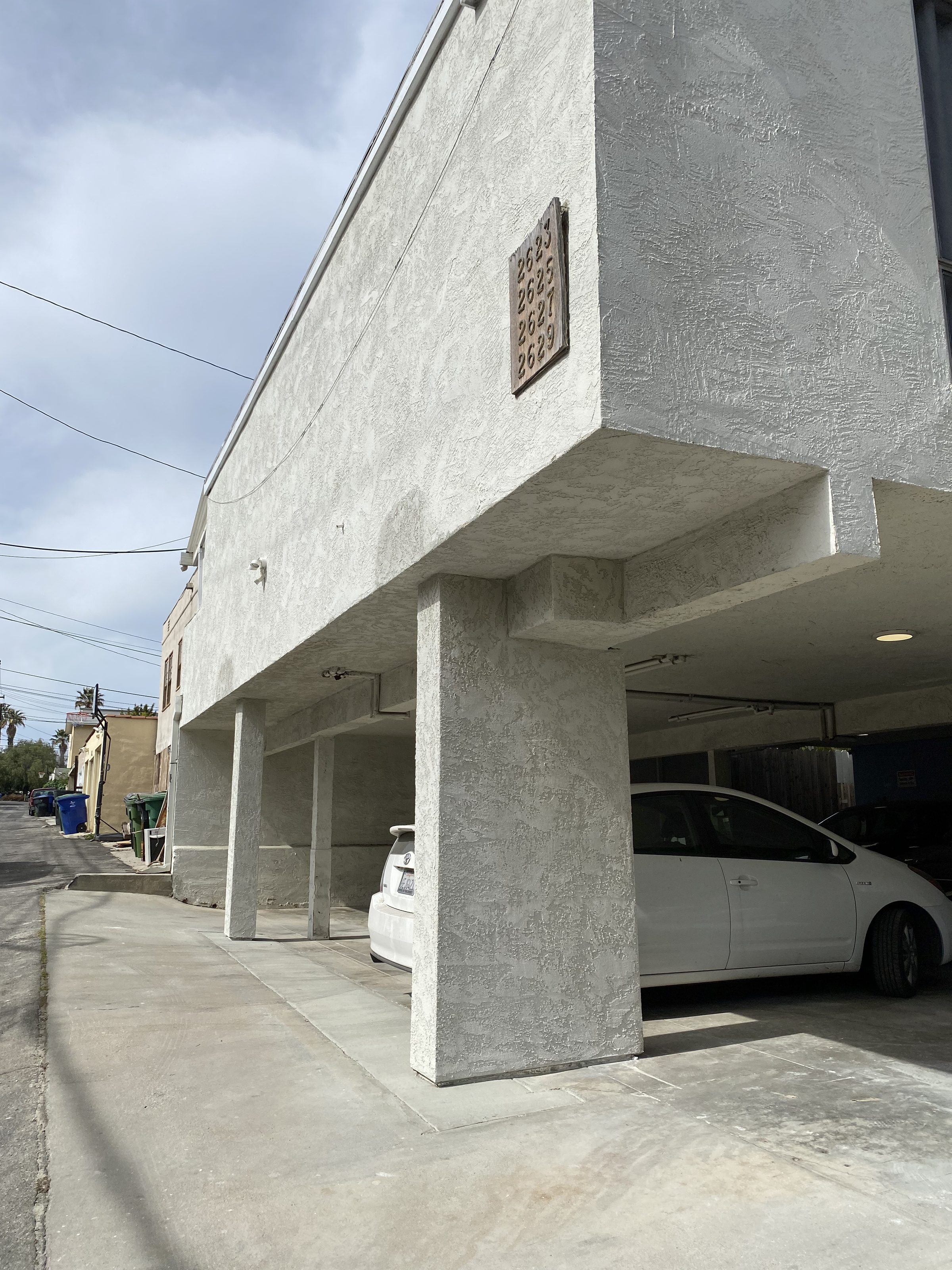 Completed exterior โ new stucco columns, fresh soffit and slab