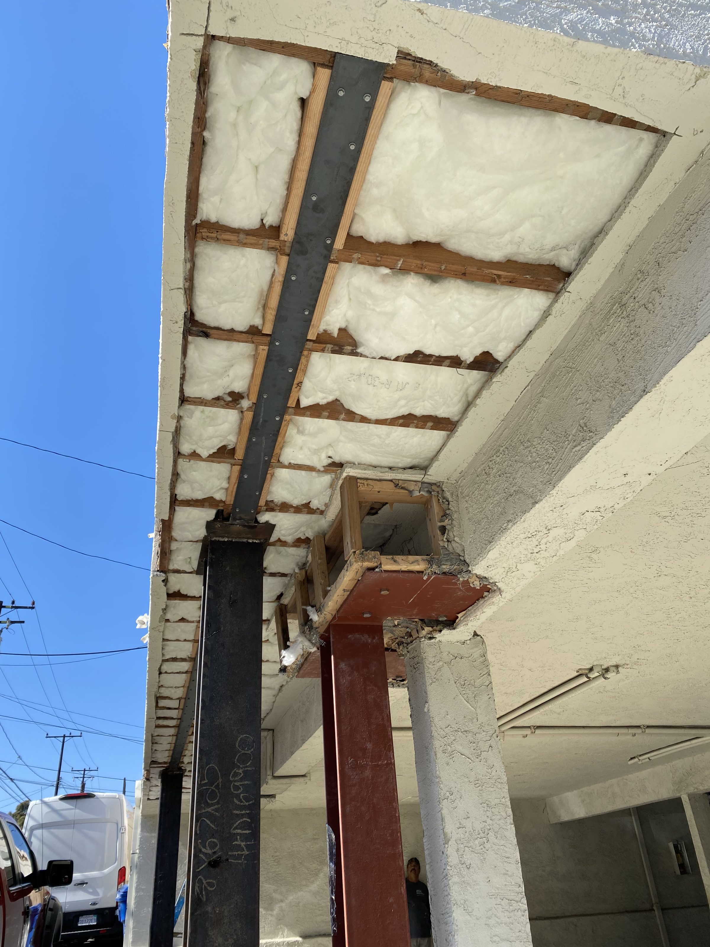 Steel column โ insulation and soffit framing visible above