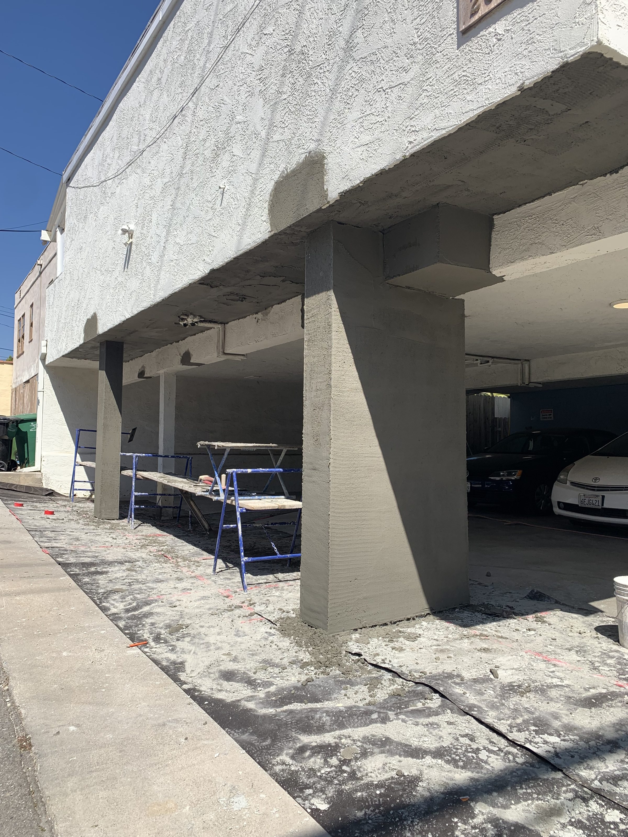 Fresh stucco on new columns โ exterior near completion