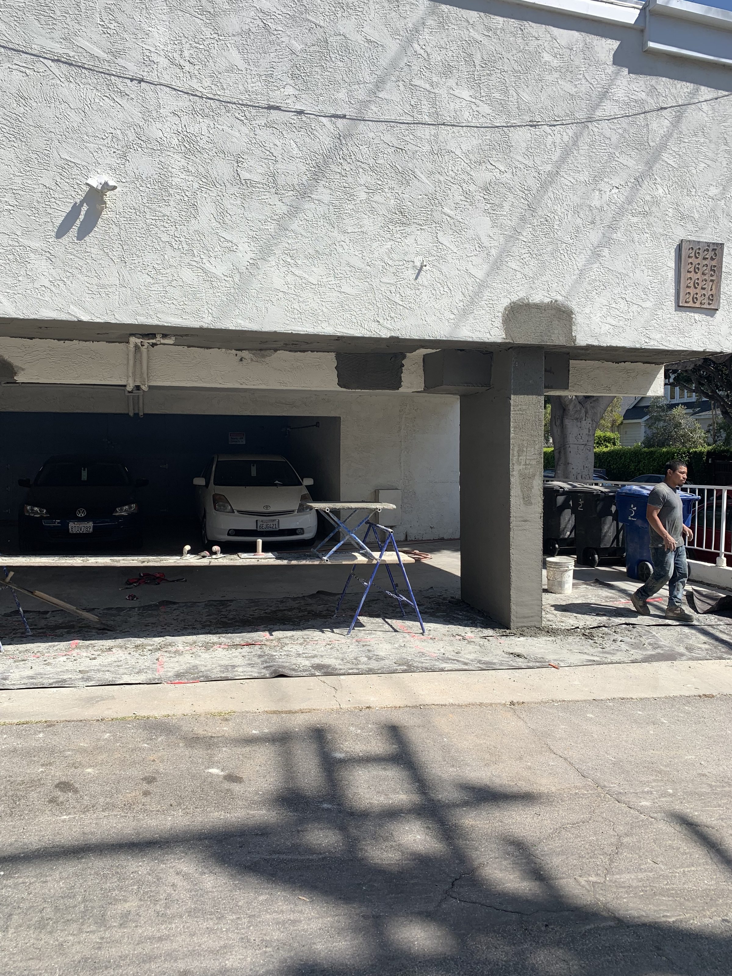Stucco columns curing โ crew finishing exterior