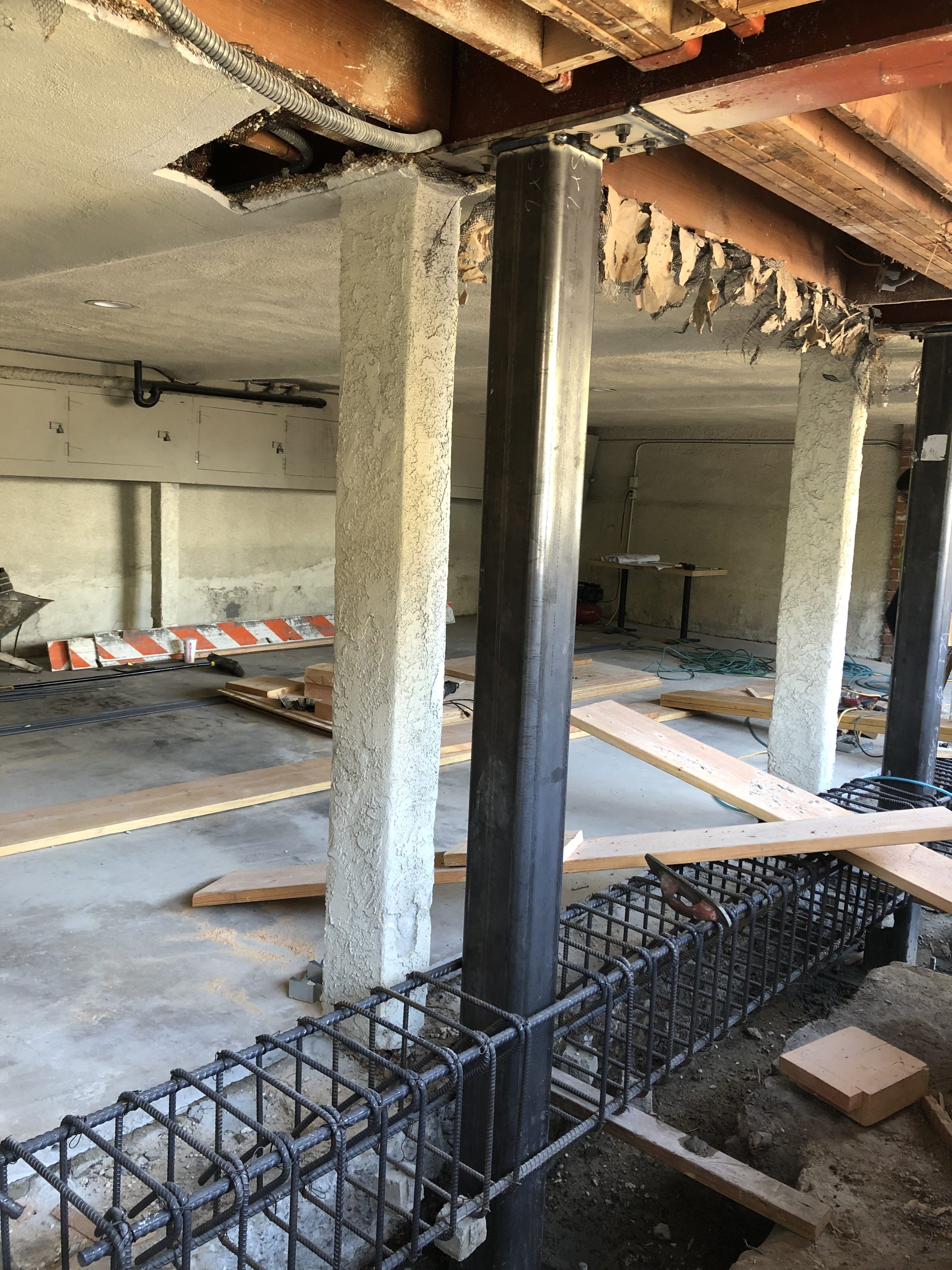 New steel column set beside existing โ rebar grade beam in progress