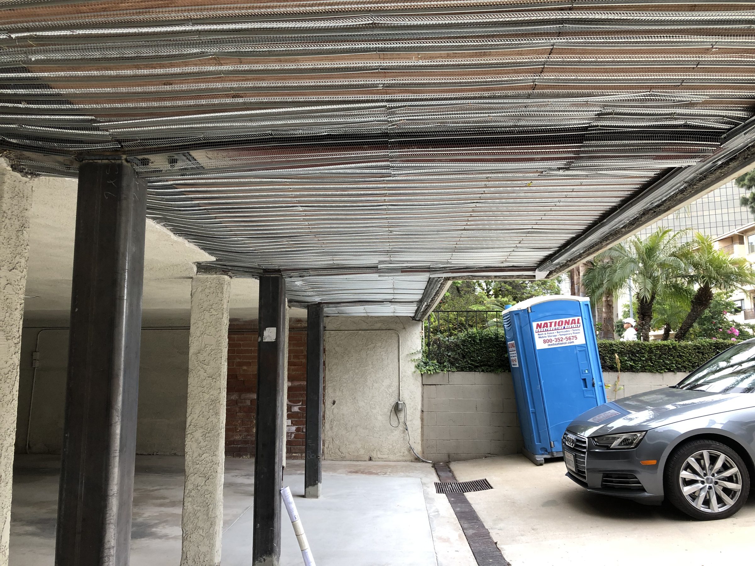 Metal lath on soffit โ full column line mid-construction