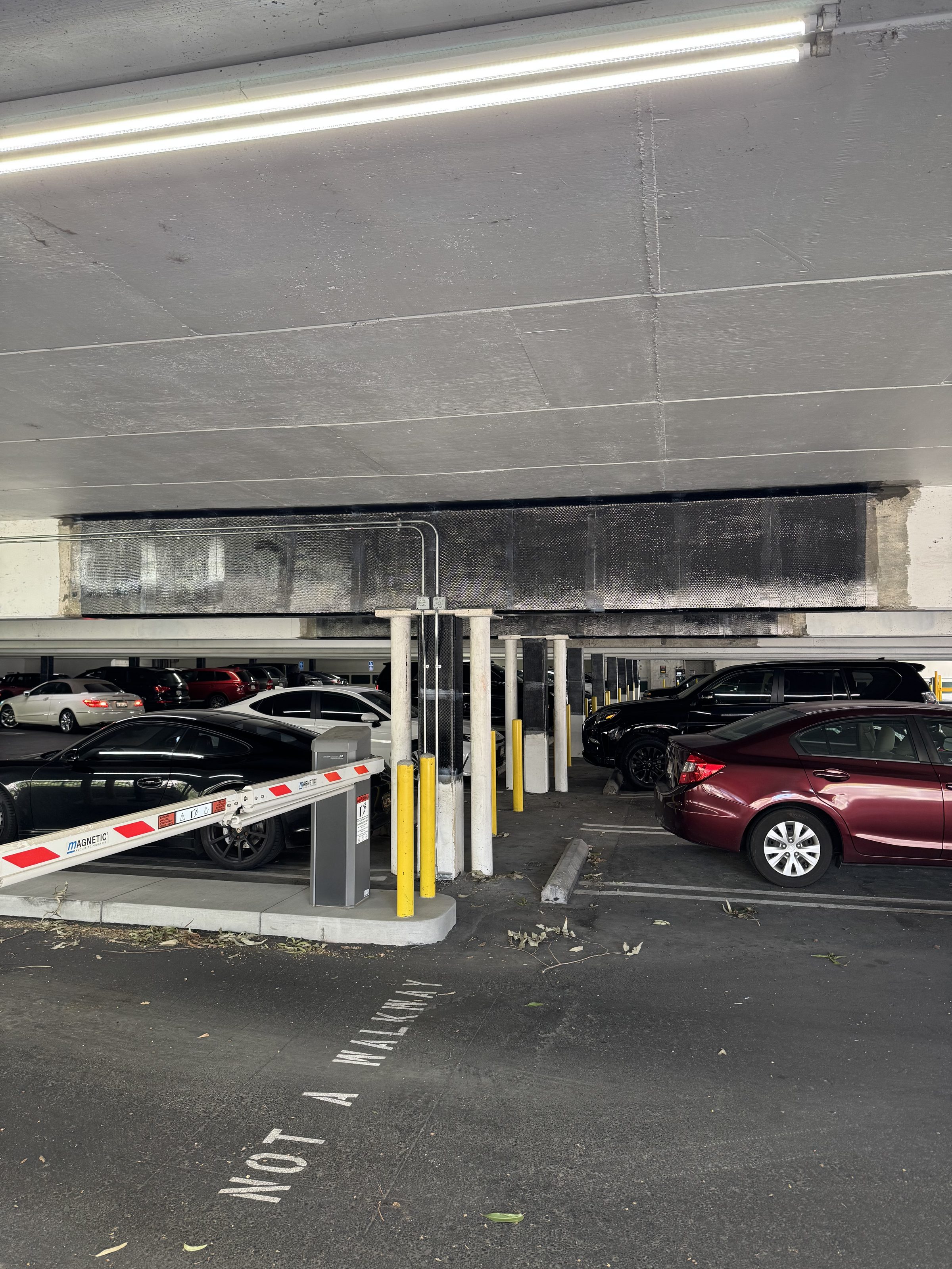 Completed CF beam wrap — active parking level with cars