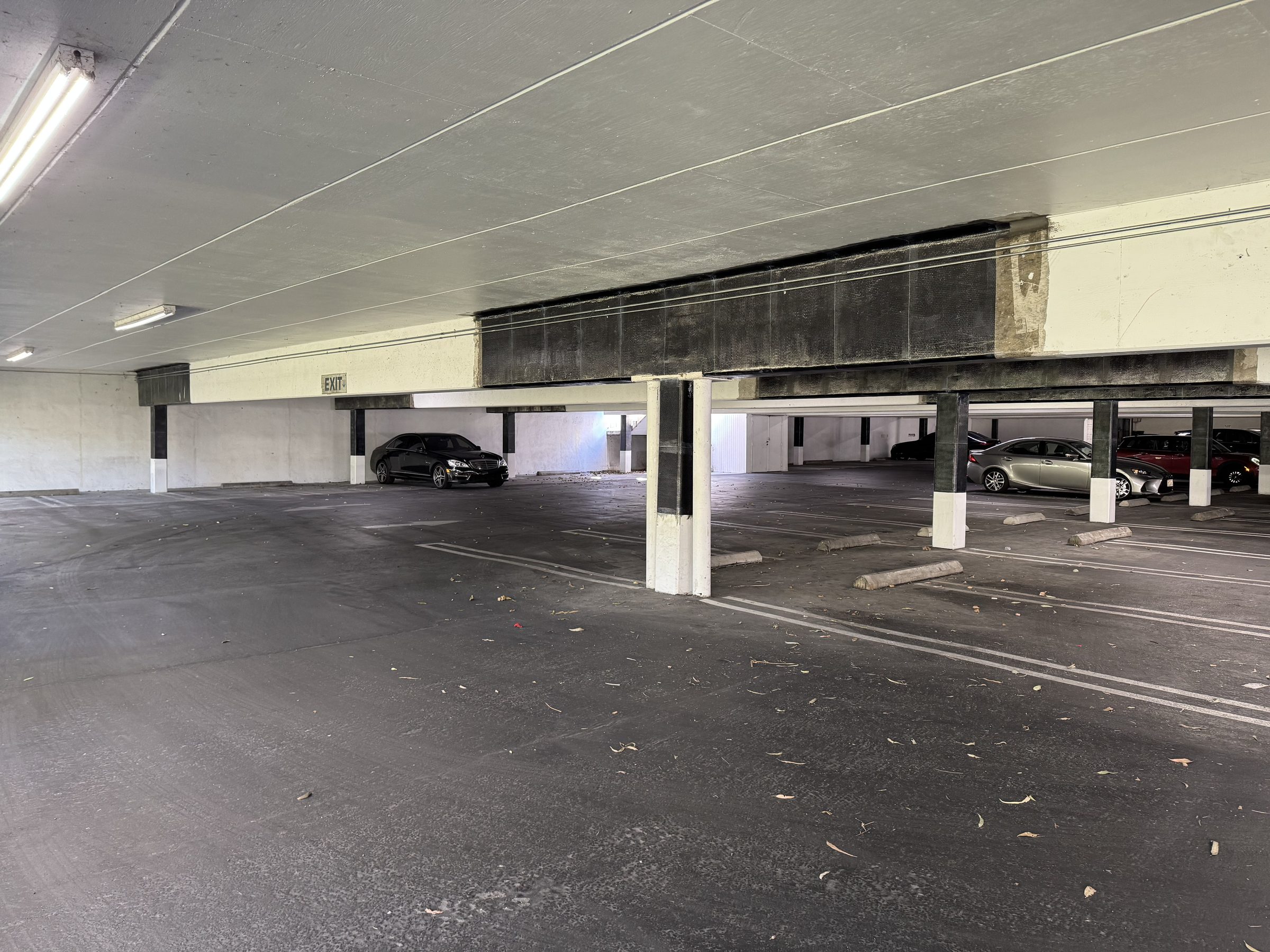 Completed CF beam wraps — full parking bay view
