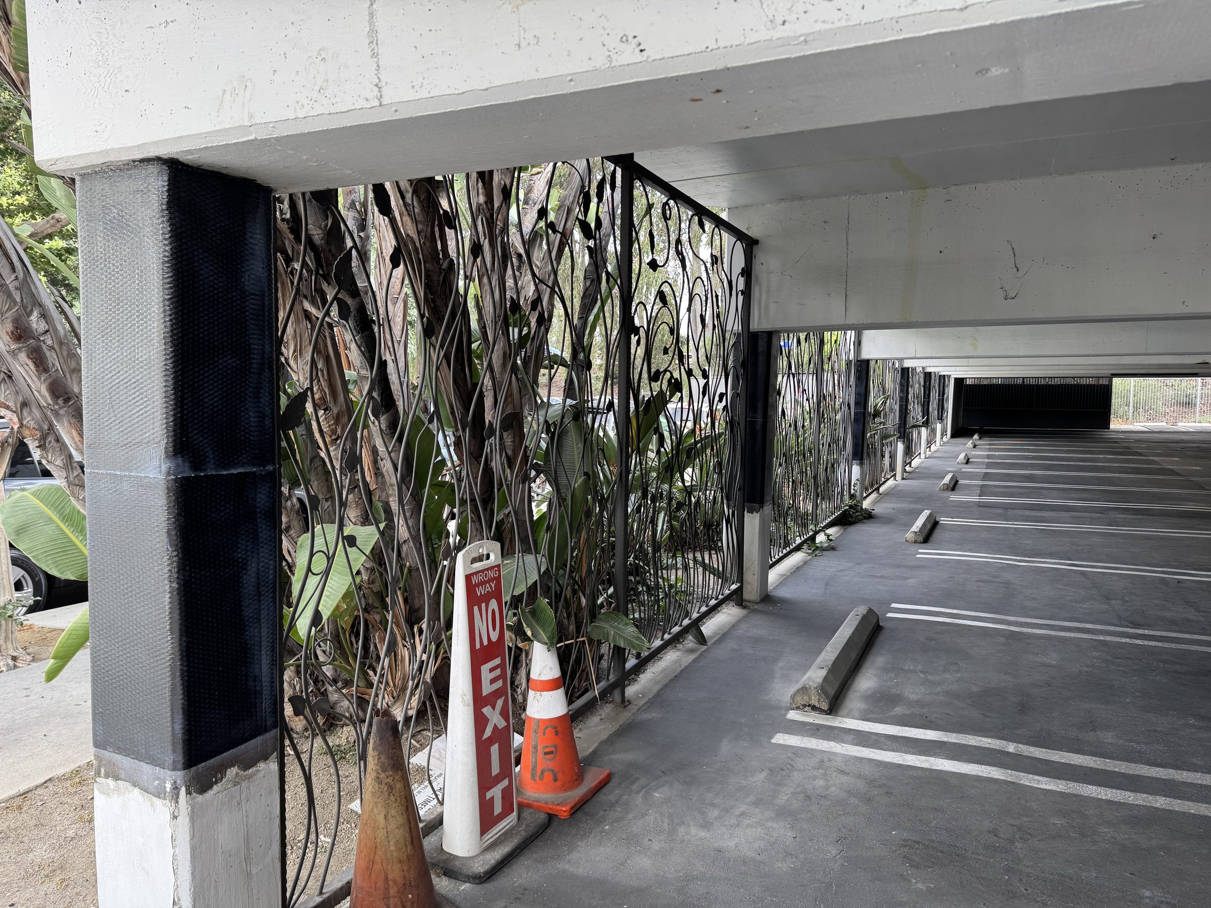 CF column wrap — close-up with decorative gate and open parking
