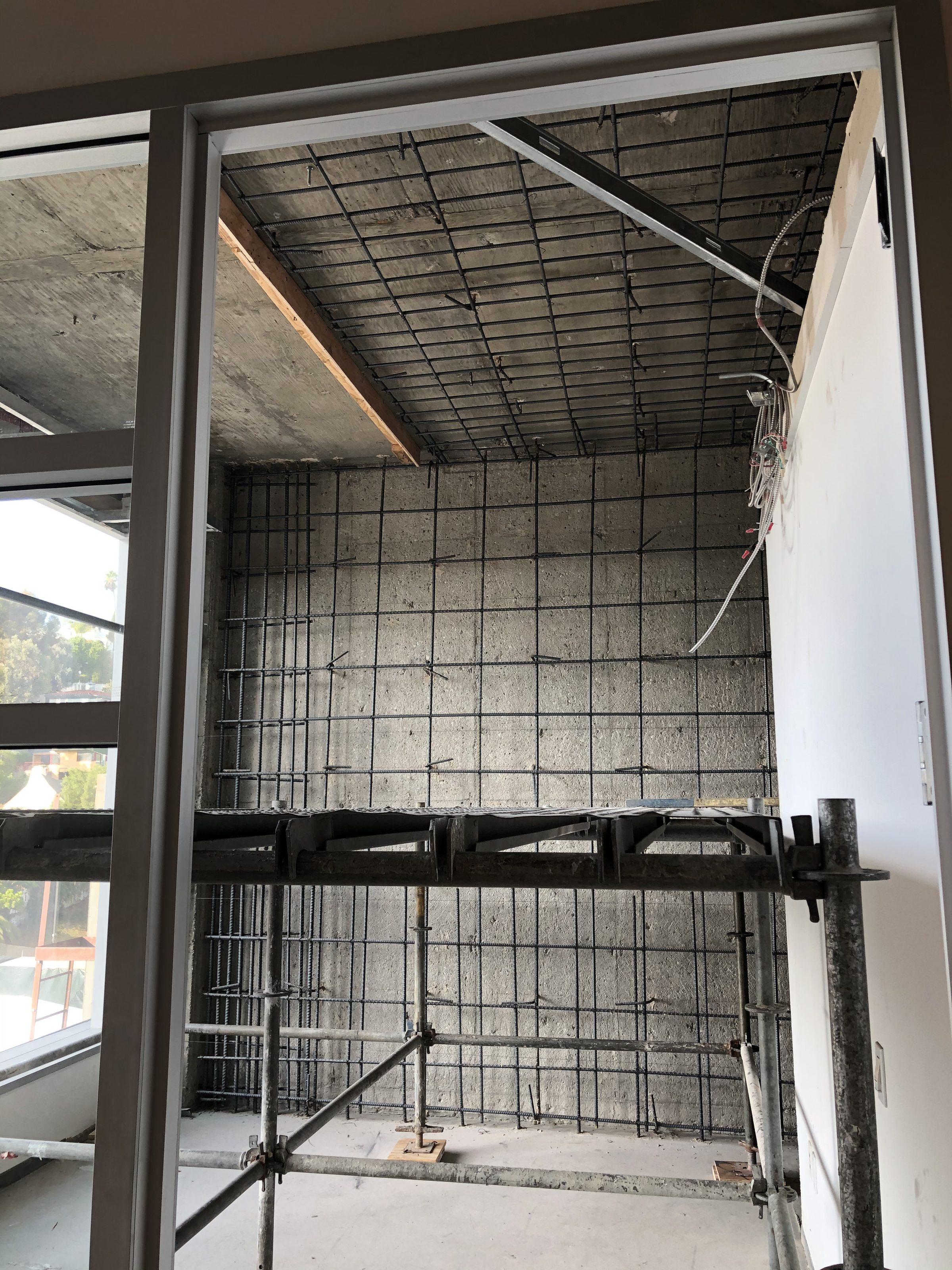 Carbon fiber column wrap — tenant space in use behind