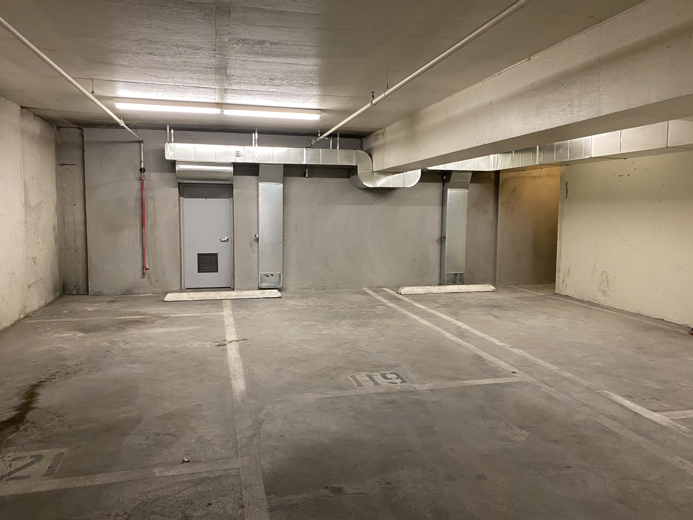 Completed garage level — painted shear walls and MEP