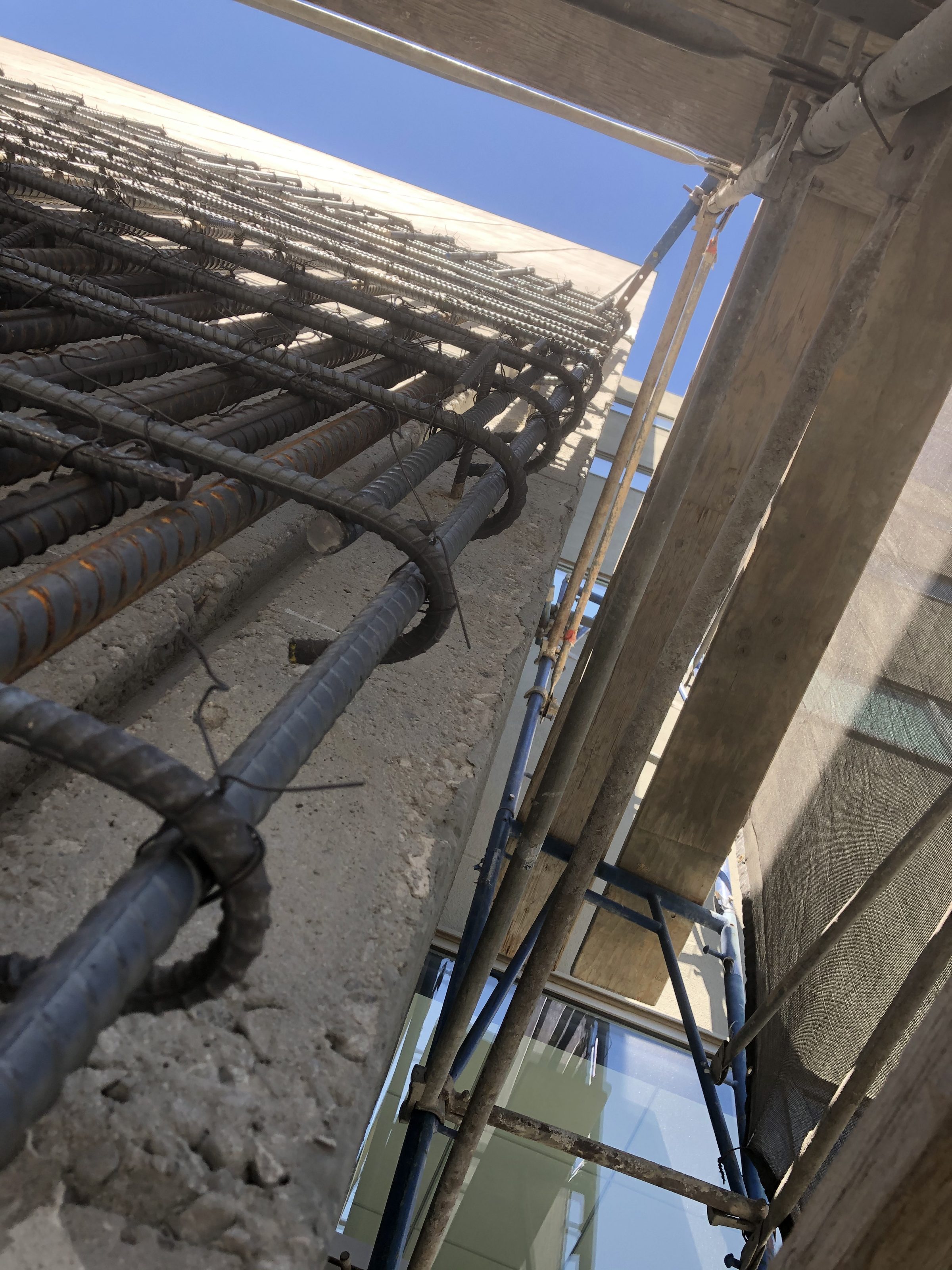 Exterior rebar — looking up building face from scaffold